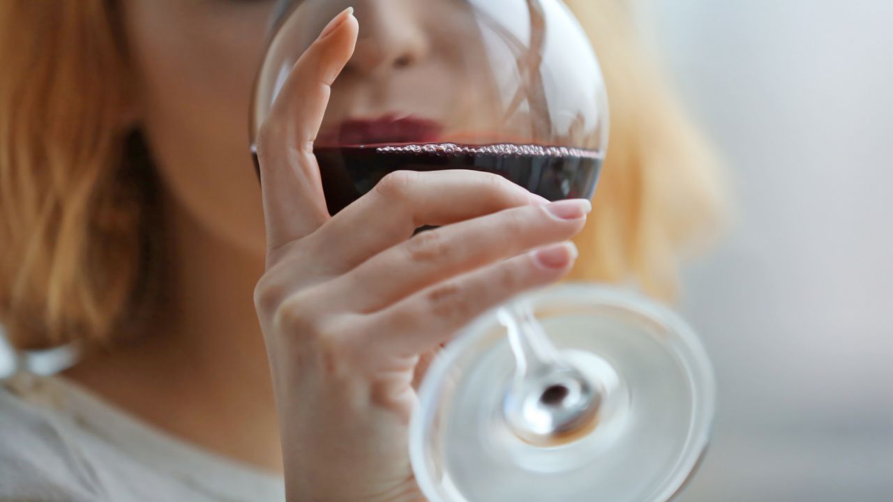 Woman with glass of red wine