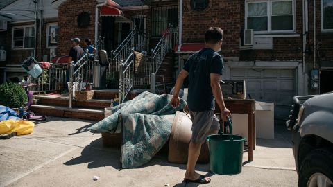 Queens residents sort through damaged and destroyed items after the remnants of Hurricane Ida swept through New York City and flooded homes in September.