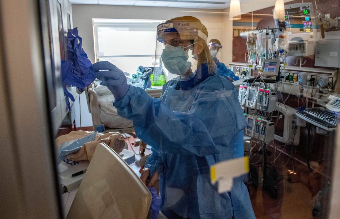 Medical workers treat a patient suffering from the effects of Covid-19 in the ICU at Hartford Hospital, Connecticut, on January 18, 2022.