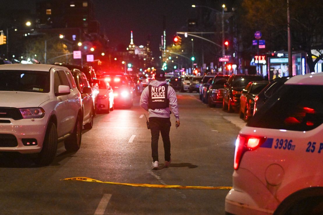 Police lock down the scene after two New York officers were shot Friday in Harlem.