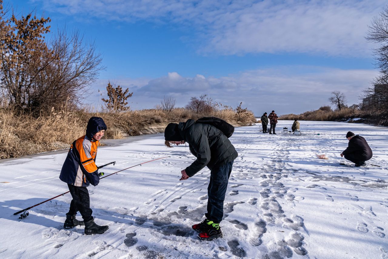 Boys fish for carp and perch in Marinka. "They don't read the news and have no opinion about the Russian military buildup," Fadek said. "But they said their parents were extremely worried and watch television news constantly."