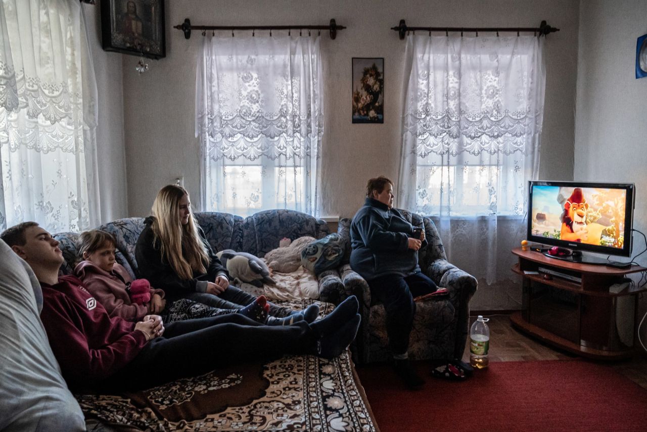 Viktoria, right, watches television with her 10-year-old daughter and her son and his girlfriend in Marinka. When asked if she had a message for the world leaders involved in the conflict Viktoria said: "Stop. Just stop. It's enough. Think about your children if they were here."