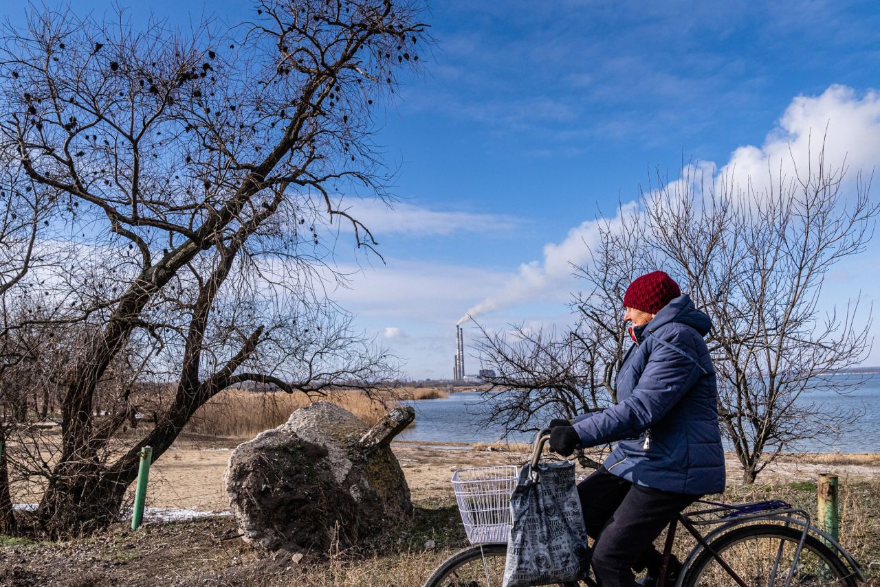 A resident rides a bicycle in Marinka. "Although this small city is less than 15 miles from the separatist front line, residents try to continue their lives as normal as possible," Fadek said.