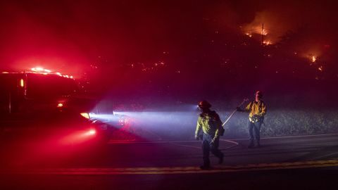 Firefighters battle the Colorado Fire burning along Highway 1 in Big Sur, California, on Saturday.