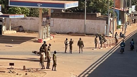 Soldiers outside a military base in Burkina Faso's capital Ouagadougou Sunday. Witnesses reported heavy gunfire nearby, raising fears that a coup attempt was underway.