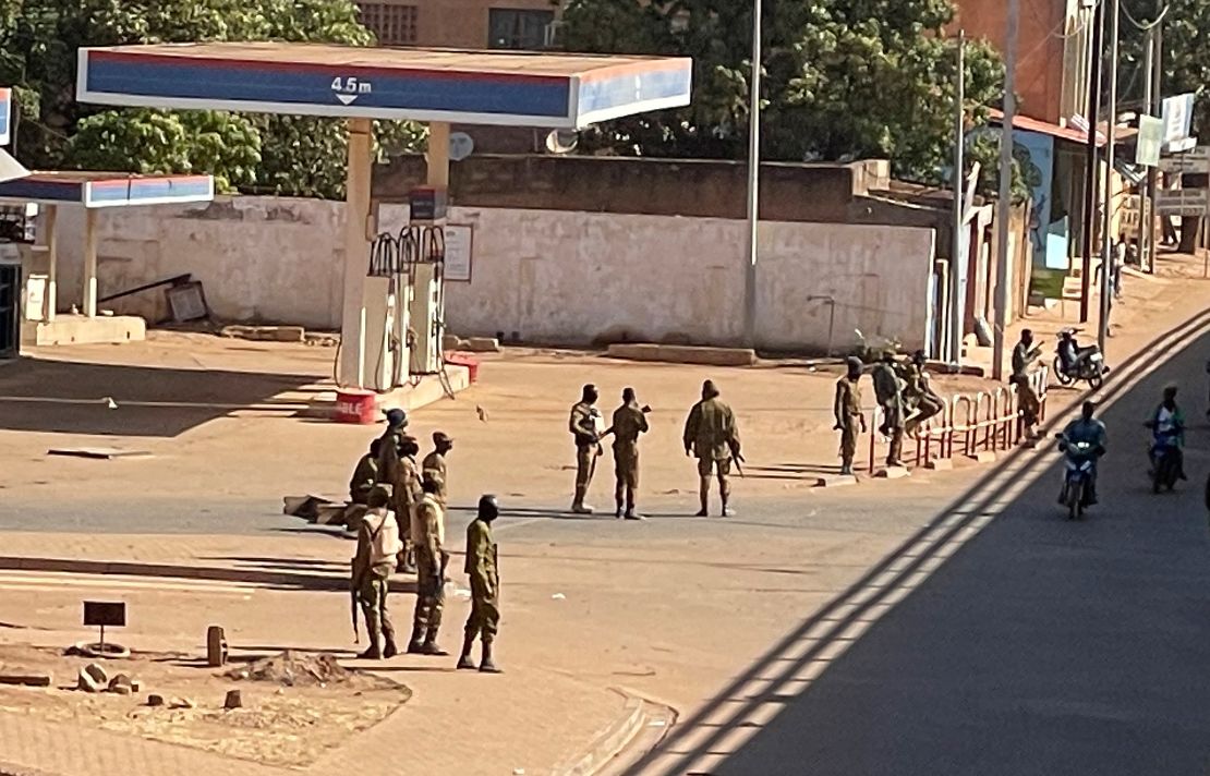 Soldiers outside a military base in Burkina Faso's capital Ouagadougou Sunday. Witnesses reported heavy gunfire nearby, raising fears that a coup attempt was underway.