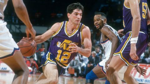 John Stockton of the Utah Jazz drives towards the basket past Michael Adams (#10) of the Washington Bullets during a 1991 NBA basketball game.