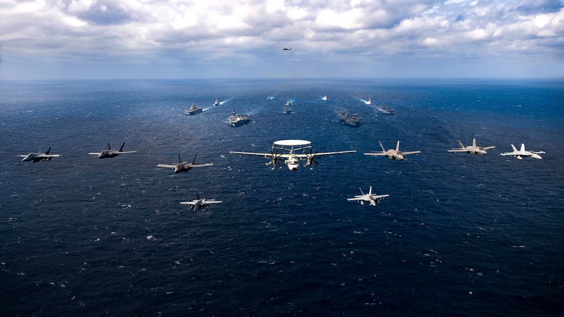 Aircraft fly over a US-Japan naval flotilla that included two US aircraft carriers in the Philippine Sea on Saturday.