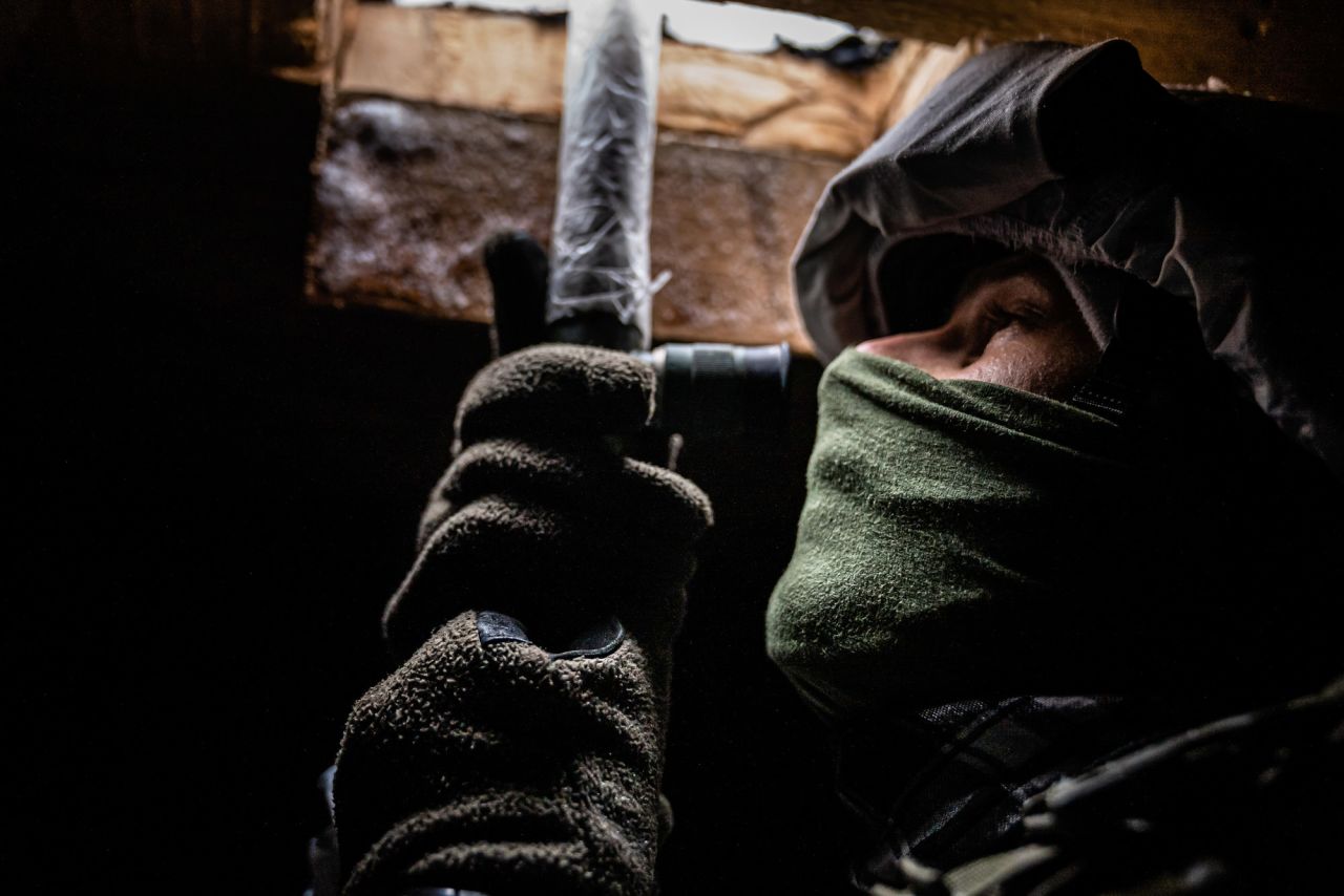 A Ukrainian soldier keeps watch in Avdiivka.