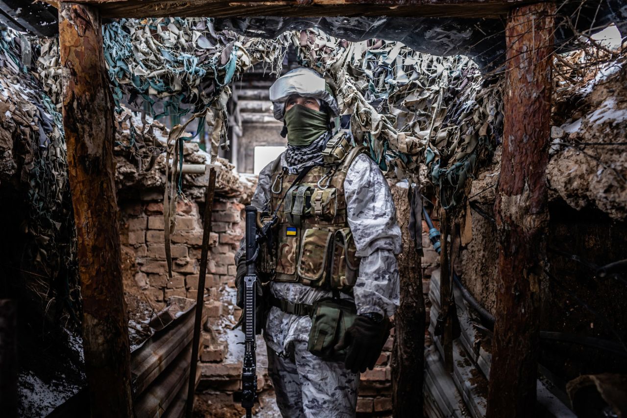 A soldier stands in a trench in Avdiivka.
