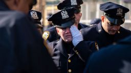 Tears are shed for slain NYPD Officer Jason Rivera as his remains are brought by procession to a funeral home Sunday in New York City.