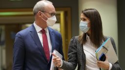 Ireland's Foreign Minister Simon Coveney, left, speaks with Belgium's Foreign Minister Sophie Wilmes during a meeting of EU foreign ministers at the European Council building in Brussels, on Jan. 24, 2022. 