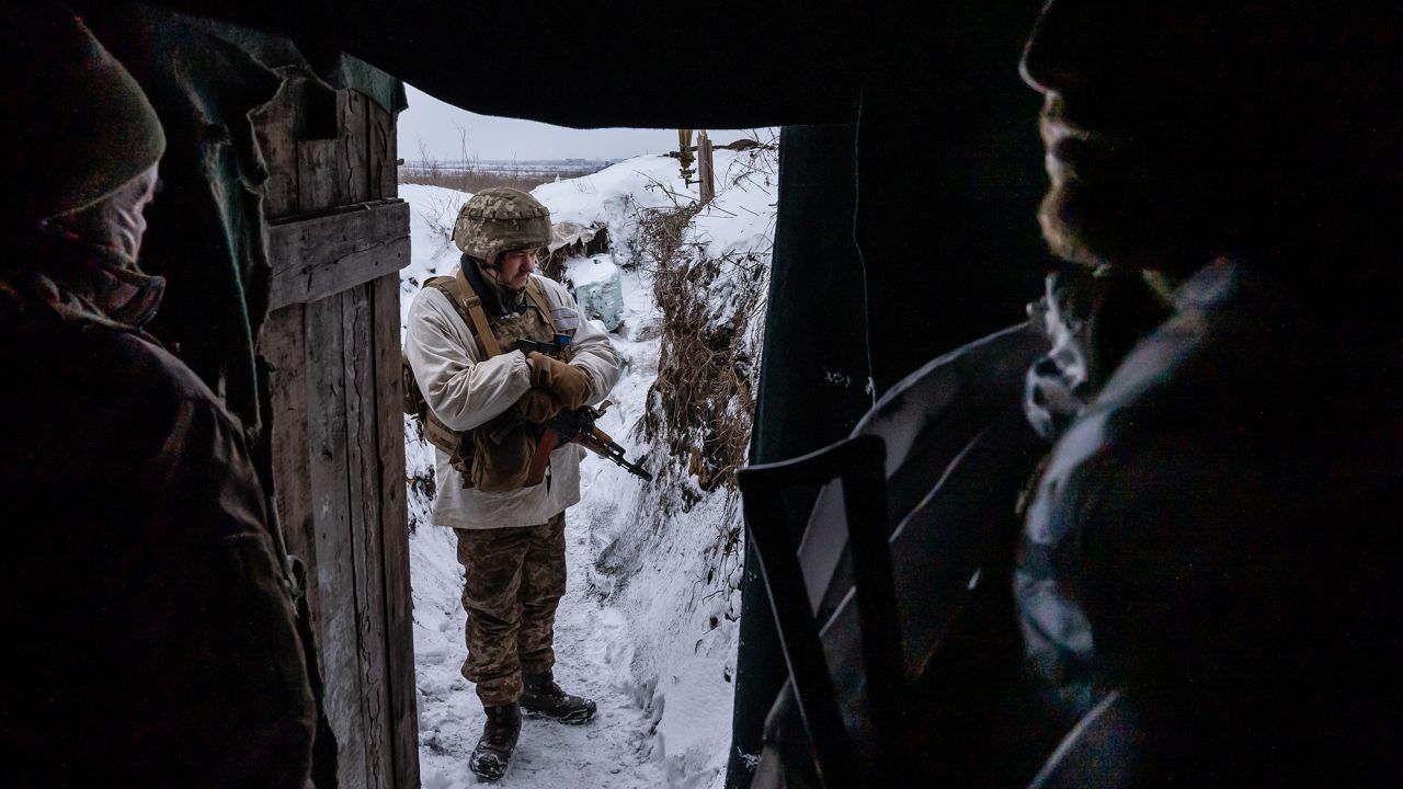 Ukrainian soldiers in a front line trench position in Donbas take shelter from the extreme cold.