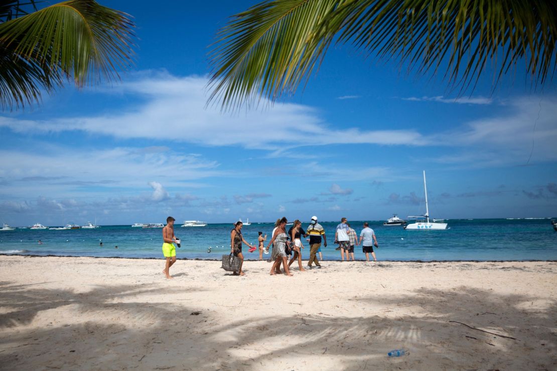 Tourists enjoy a beach in Punta Cana in the Dominican Republic, on January 7, 2022. - Almost 5 million tourists visited Dominican Republic in 2021, compared to the 6.4 million reported in 2019 before the pandemic started. With a significant growth in tourism and at the same time of infections by Covid-19, hotels in the Dominican Republic allocate areas to isolate tourists sick with the virus. (Photo by Erika SANTELICES / AFP) (Photo by ERIKA SANTELICES/afp/AFP via Getty Images)