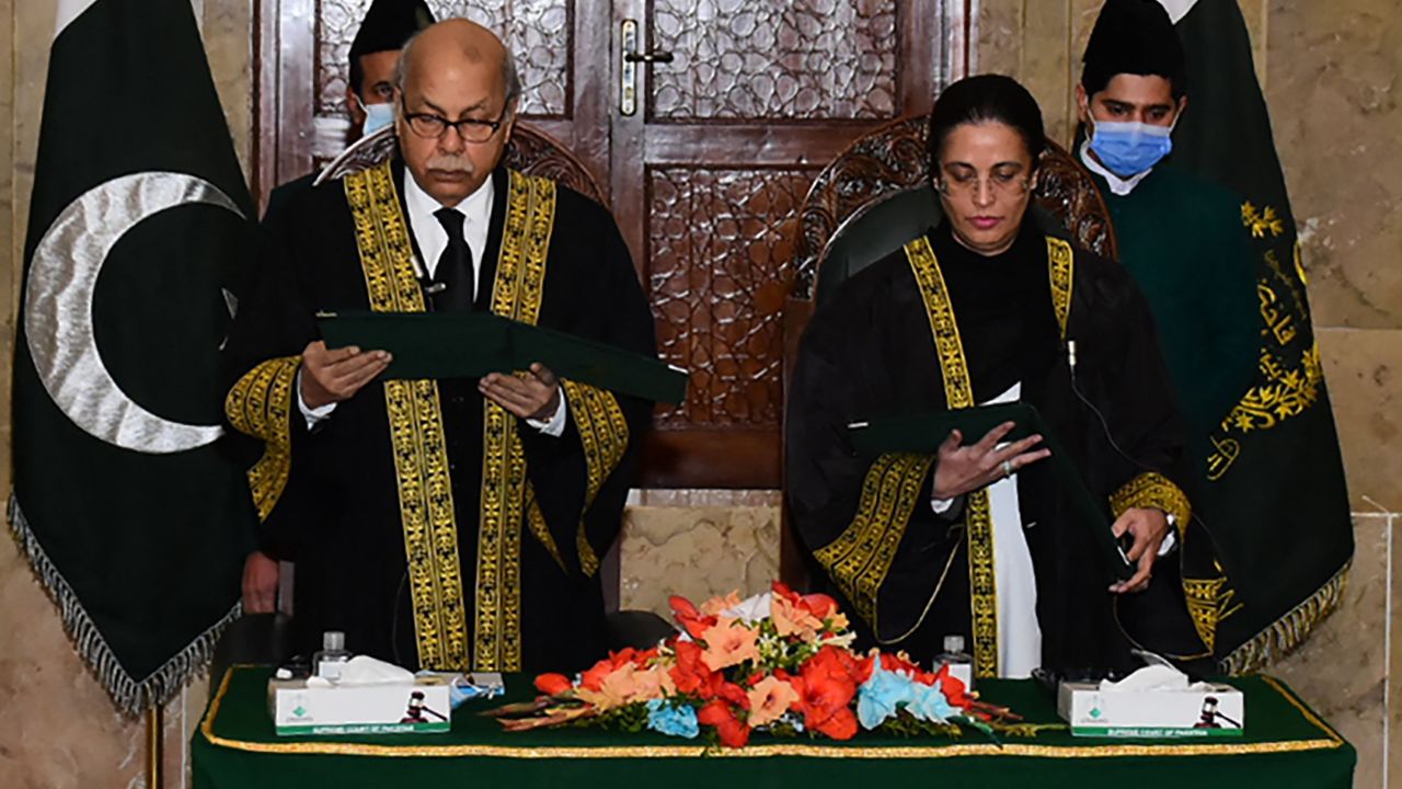 Chief Justice Gulzar Ahmad (left) administering the oath to Justice Ayesha Malik as Pakistan's first female Supreme Court judge in Islamabad on January 24, 2022. 