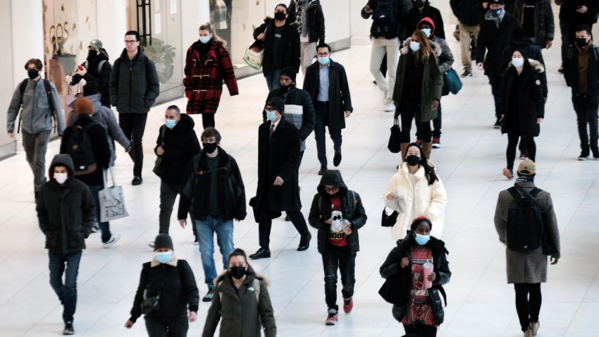  People wear masks at an indoor mall in The Oculus in lower Manhattan on the day that a mask mandate went into effect in New York on December 13, 2021 in New York City.