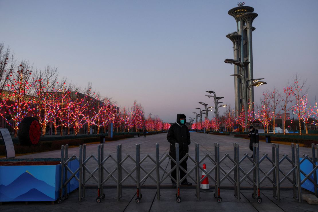 A security guard keeps watch at the boundary of the closed loop "bubble" near the Main Media Center of the Winter Olympics in Beijing, January 25, 2022.