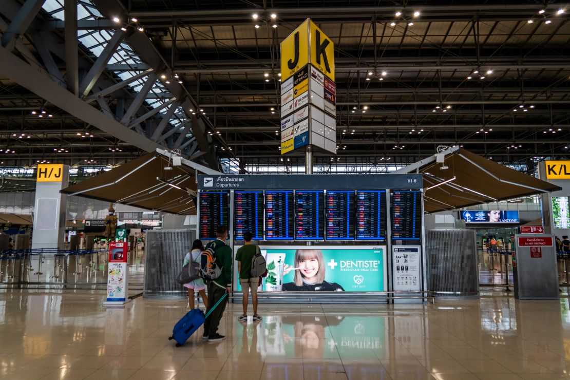 Travelers pass through an empty Suvarnabhumi Airport on January 1, 2022.  