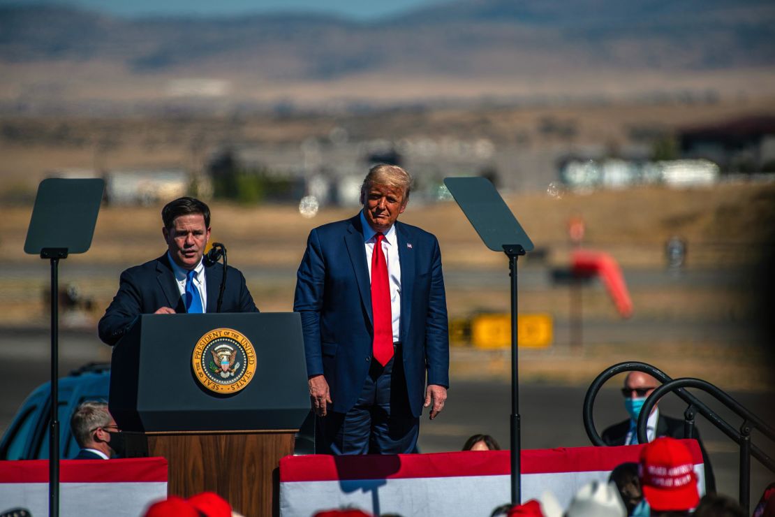 Doug Ducey, governor of Arizona, speaks during a Make America Great Again rally with then President Donald Trump, right, in Prescott, Arizona, in October 2020.