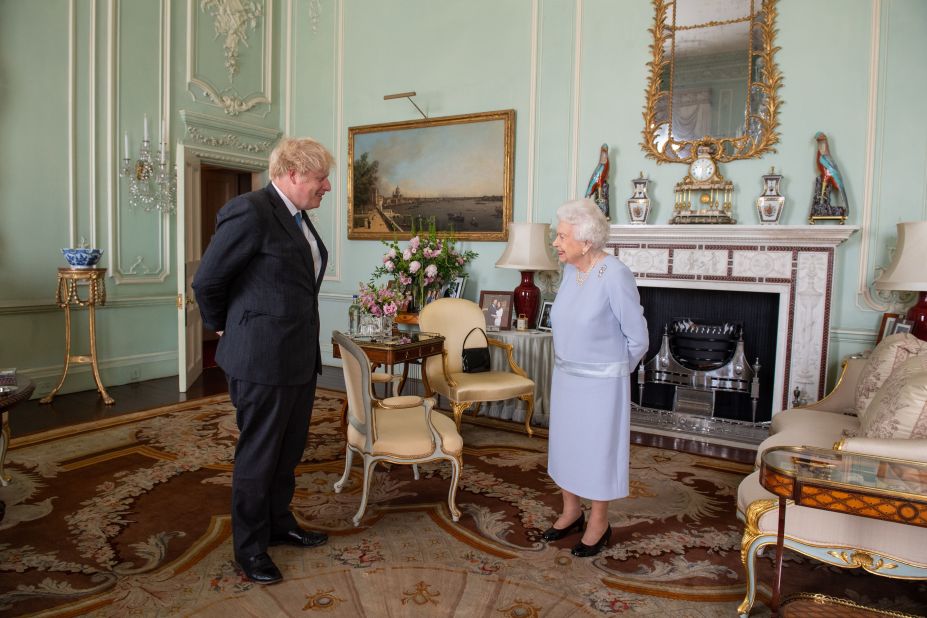 Queen Elizabeth II greets Johnson at Buckingham Palace in June 2021. It was the Queen's first in-person weekly audience with the Prime Minister since the start of the coronavirus pandemic.