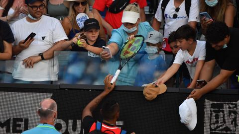 Kyrgios (bottom C) gives a racket to a boy he had hit with a tennis ball.