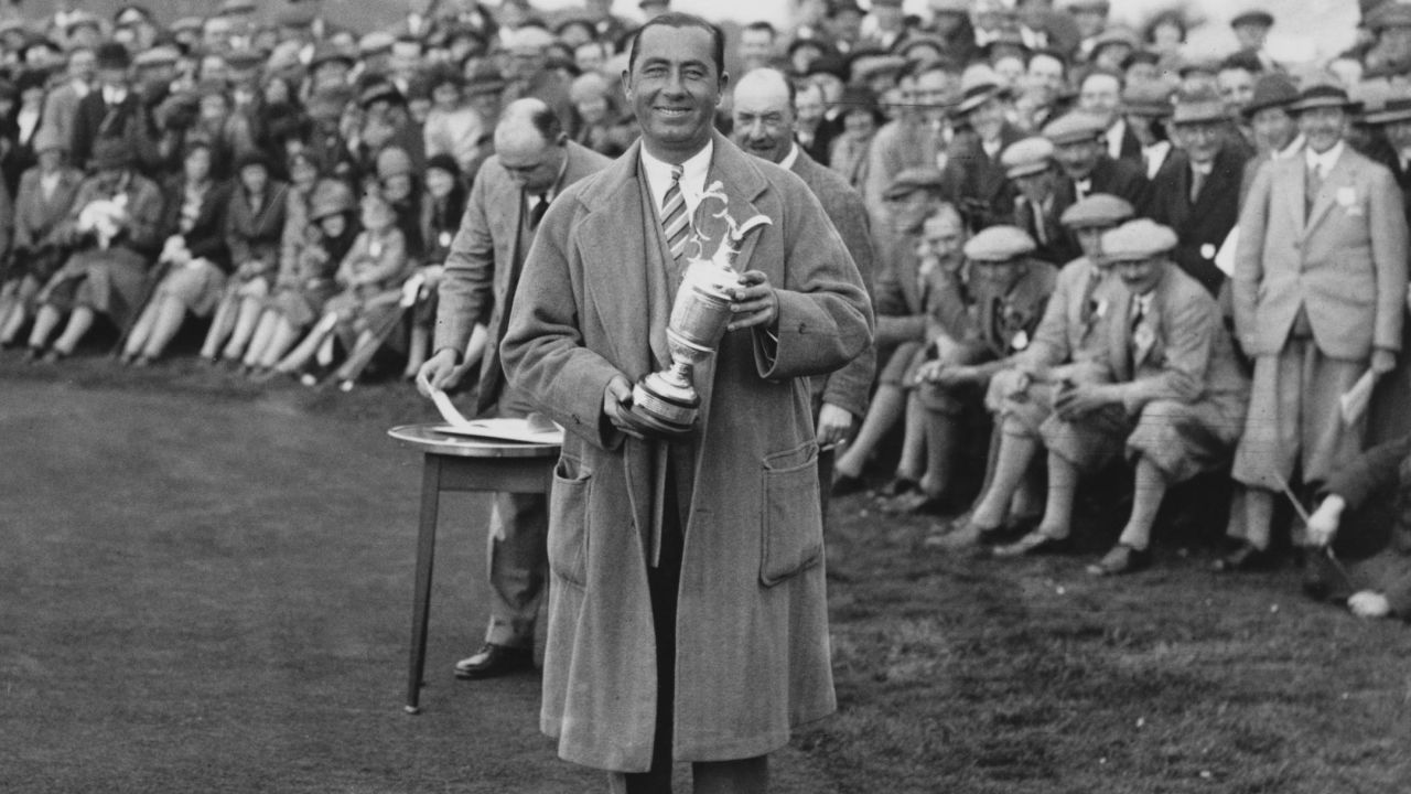 Hagen, holding the Claret Jug, on the 1st tee during an exhibition match with Joe Kirkwood at Llanwern, South Wales in 1937. 