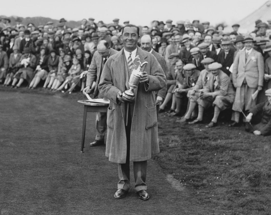 Hagen, holding the Claret Jug, on the 1st tee during an exhibition match with Joe Kirkwood at Llanwern, South Wales in 1937. 