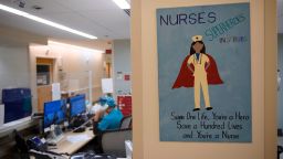 A poster in support of nurses hangs at a nurses station on a Covid-19 patent care floor at Martin Luther King Jr. (MLK) Community Hospital on January 6, 2021 in the Willowbrook neighborhood of Los Angeles, California. - Deep within a South Los Angeles hospital, a row of elderly Hispanic men in induced comas lay hooked up to ventilators, while nurses clad in spacesuit-looking respirators checked their bleeping monitors in the eerie silence. The intensive care unit in one of the city's poorest districts is well accustomed to death, but with Los Angeles now at the heart of the United States' Covid pandemic, medics say they have never seen anything on this scale. (Photo by Patrick T. FALLON / AFP) (Photo by PATRICK T. FALLON/AFP via Getty Images)