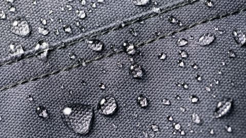 A close-up of a water-resistant textile is shown.