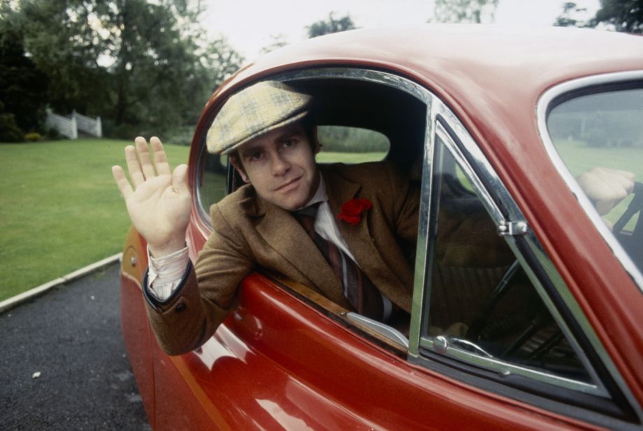 John waves from his car in 1978.