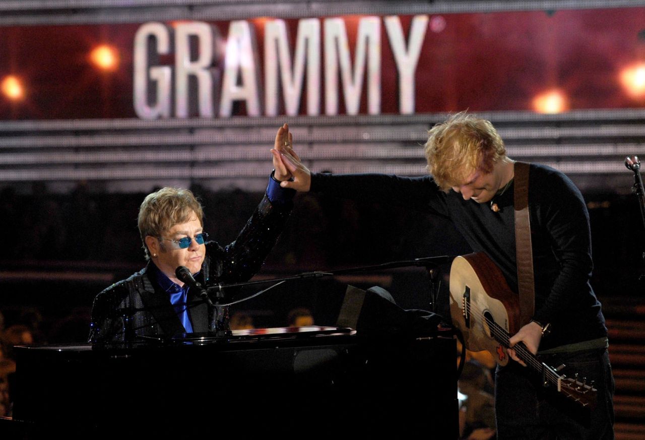 John performs with Ed Sheeran at the 2013 Grammy Awards. They teamed up for Sheeran's song "The A Team."