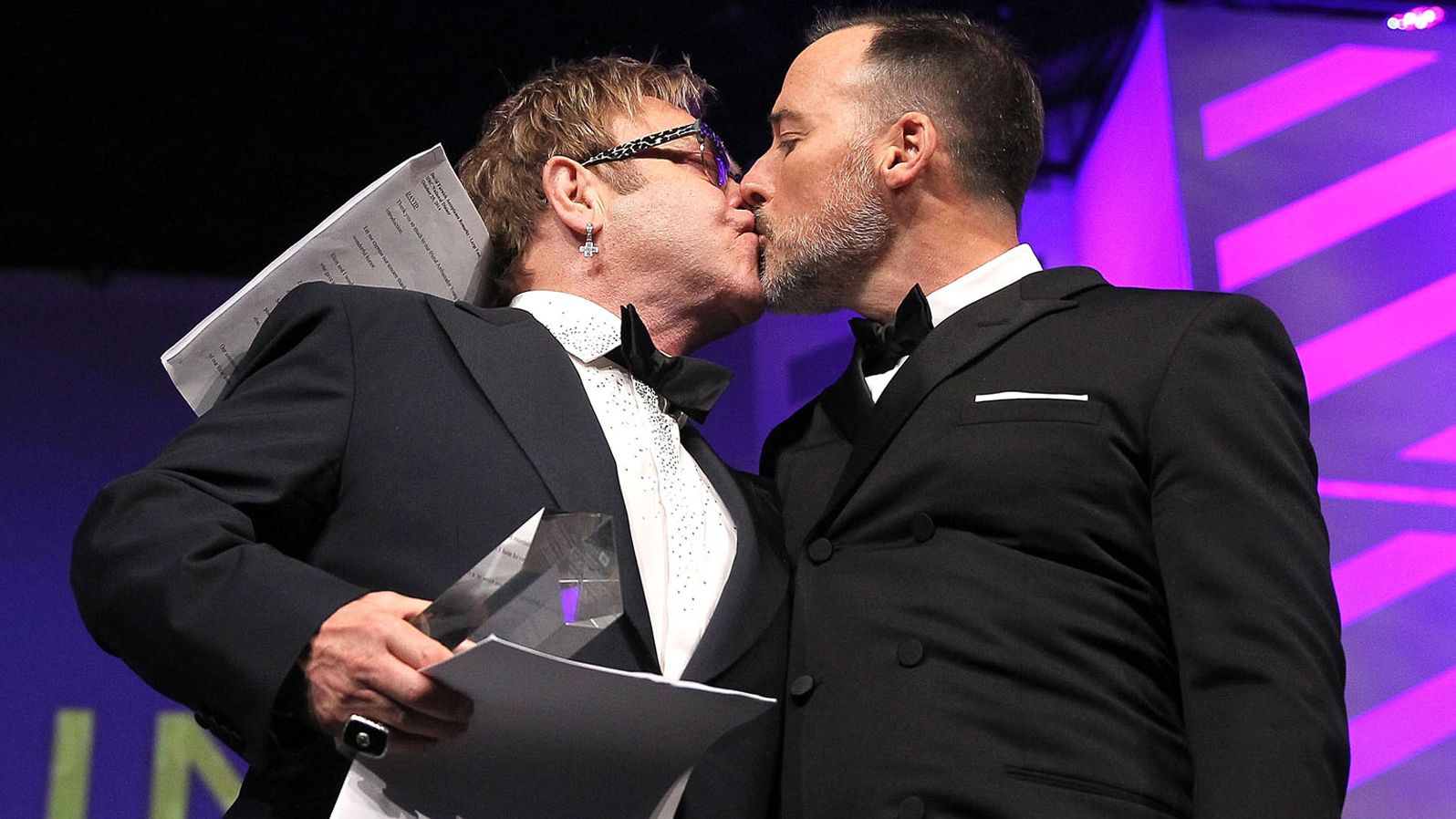 John and Furnish kiss at the Human Rights Campaign's National Dinner in 2014. They married in December of that year.
