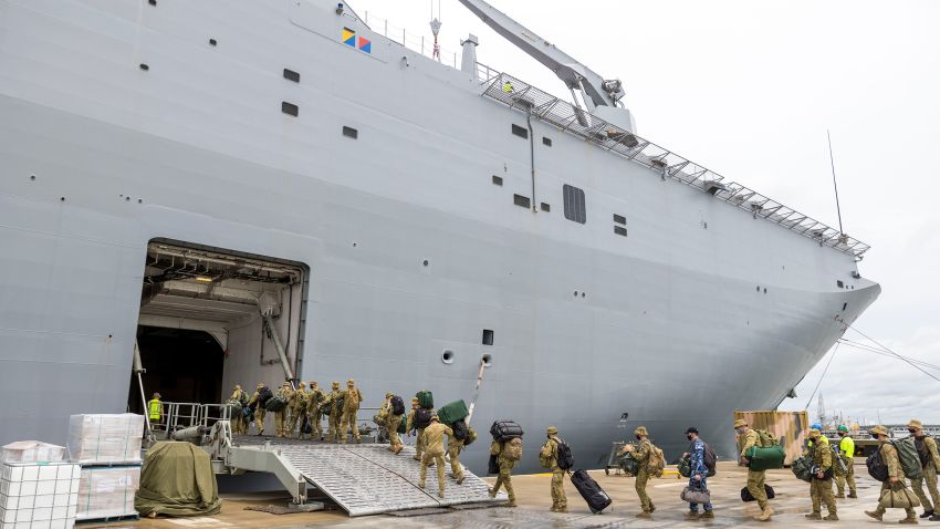 NUKU'ALOFA, TONGA - JANUARY 20: In this handout image provided by the Australian Defence Force, members of the Australian Defence Force board the HMAS Adelaide as they prepare to depart for an aid mission at the Port of Brisbane on January 20, 2022 in Nuku'alofa, Tonga. The undersea Hunga Tonga-Hunga Ha'apai volcano near Tonga erupted on Saturday 15 January, causing a subsequent tsunami in the nearby Tongan capital of Nuku'alofa and surrounding islands as well as triggering tsunami warnings across the Pacific region. (Photo by CPL Robert Whitmore/Australian Defence Force via Getty Images)