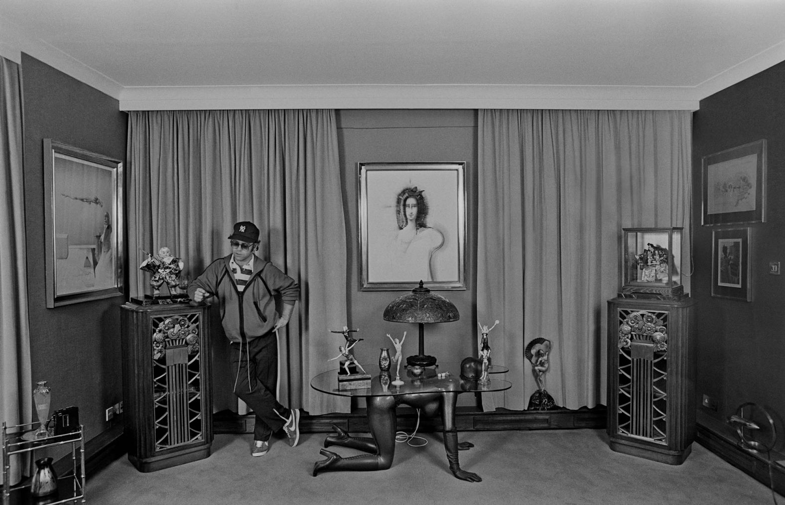 John stands in the bedroom of his home in Old Windsor, England, in 1978.