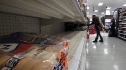 A shopper walks past partially empty bread shelves at a Target store in the Queens borough of New York City, NY, January 17, 2022. 