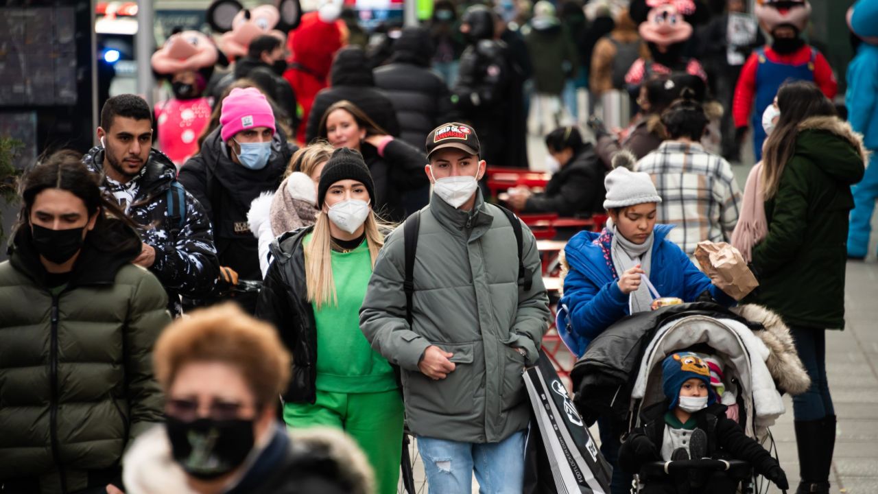 People wear face masks in Times Square on Tuesday in New York City. 