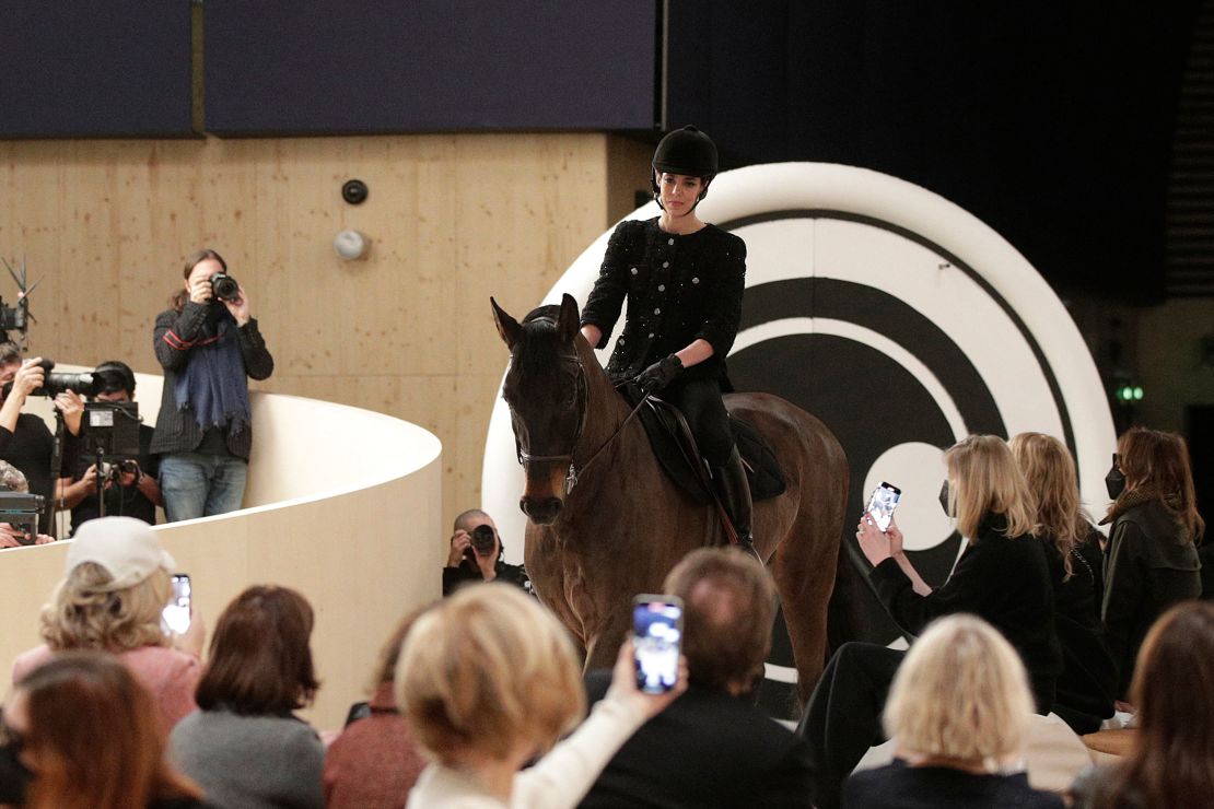 Charlotte Casiraghi rides a horse at the start of the Spring-Summer 2022 Chanel Haute Couture collection fashion show in Paris on Tuesday.
