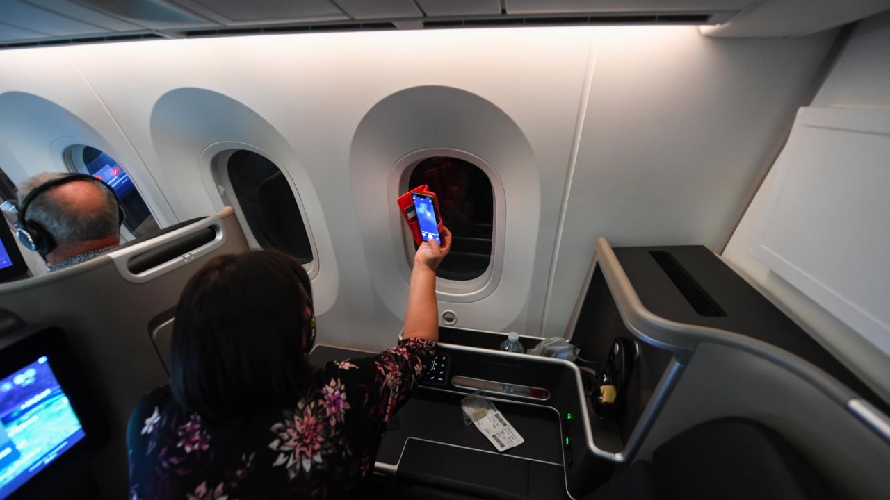 A passenger trying to capture a photo of the supermoon from Qantas' Supermoon scenic flight in May 2021.