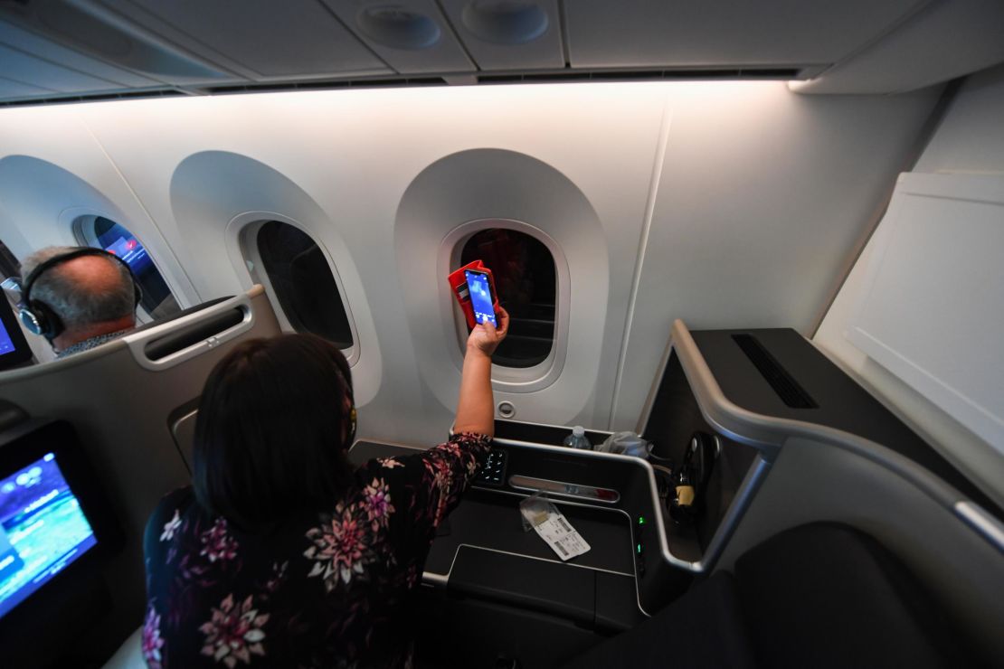 A passenger trying to capture a photo of the supermoon from Qantas' Supermoon scenic flight in May 2021.
