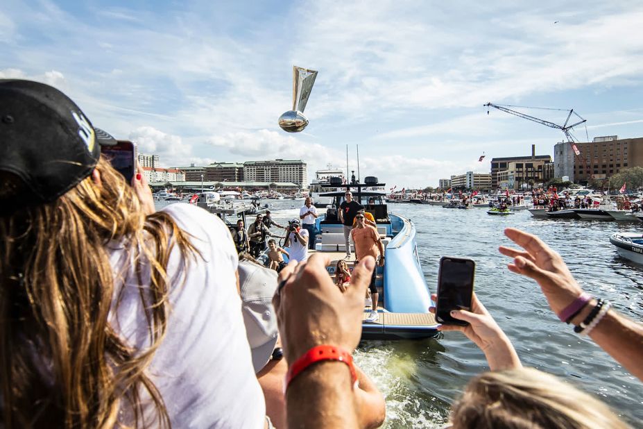 Brady throws the Vince Lombardi Trophy to teammates as they celebrate their title during a boat parade in Tampa, Florida, in February 2021.