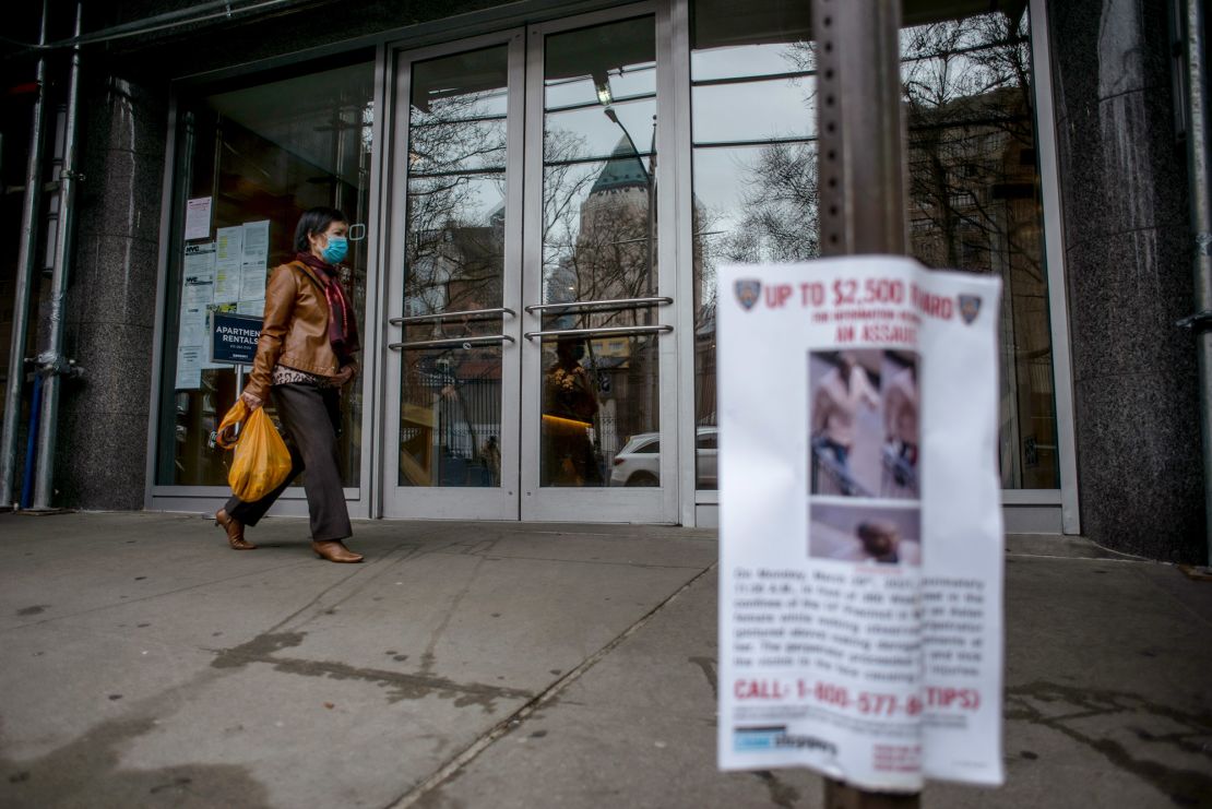 A woman walks past the New York apartments where Vilma Kari was attacked in March 2021.