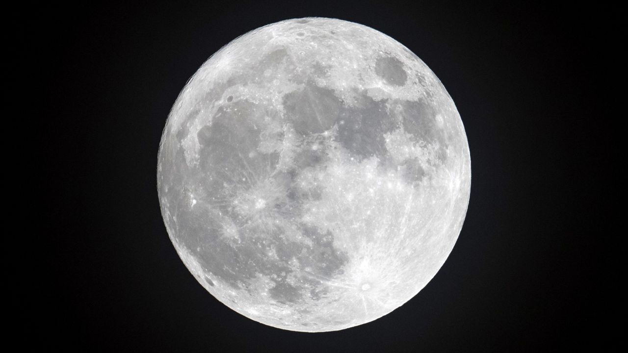 PENZANCE, ENGLAND - DECEMBER 13:  Clouds clear to allow a view of the final full moon of the year, a so-called 'Cold Moon', as it appears behind lights illuminating Penzance seafront on December 13, 2016 in Cornwall, England. The last full moon of the year was also the final supermoon of 2016. The natural phenomenon occurs when the perigee (closest approach by the Moon to Earth) coincides with it being full (completely illuminated by the Sun).  (Photo by Matt Cardy/Getty Images)