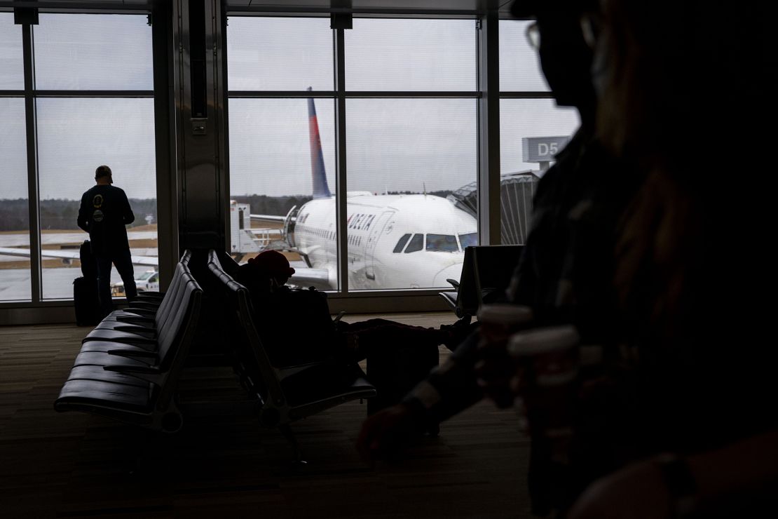 Travelers walk through terminal 2 at Raleigh-Durham International Airport (RDU) in Morrisville, North Carolina, U.S., on Thursday, Jan. 20, 2022.