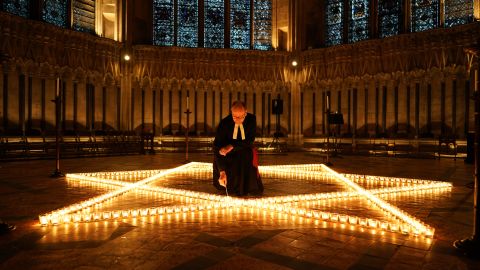 The Reverend Canon Michael Smith, acting Dean of York, lights some of the 600 candles shaped as a Star of David on the floor of the Chapter House of York Minster as part of a commemoration for Holocaust Memorial Day on Wednesday in York, England.