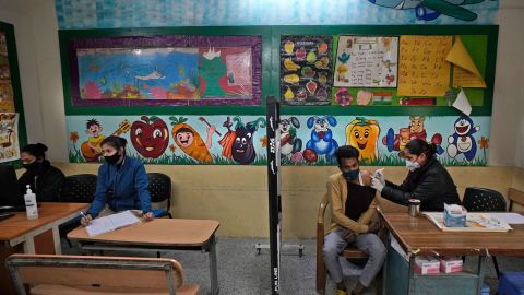 A health worker administers a Covid-19 vaccine at a government school, in New Delhi, India on January 20, 2022.