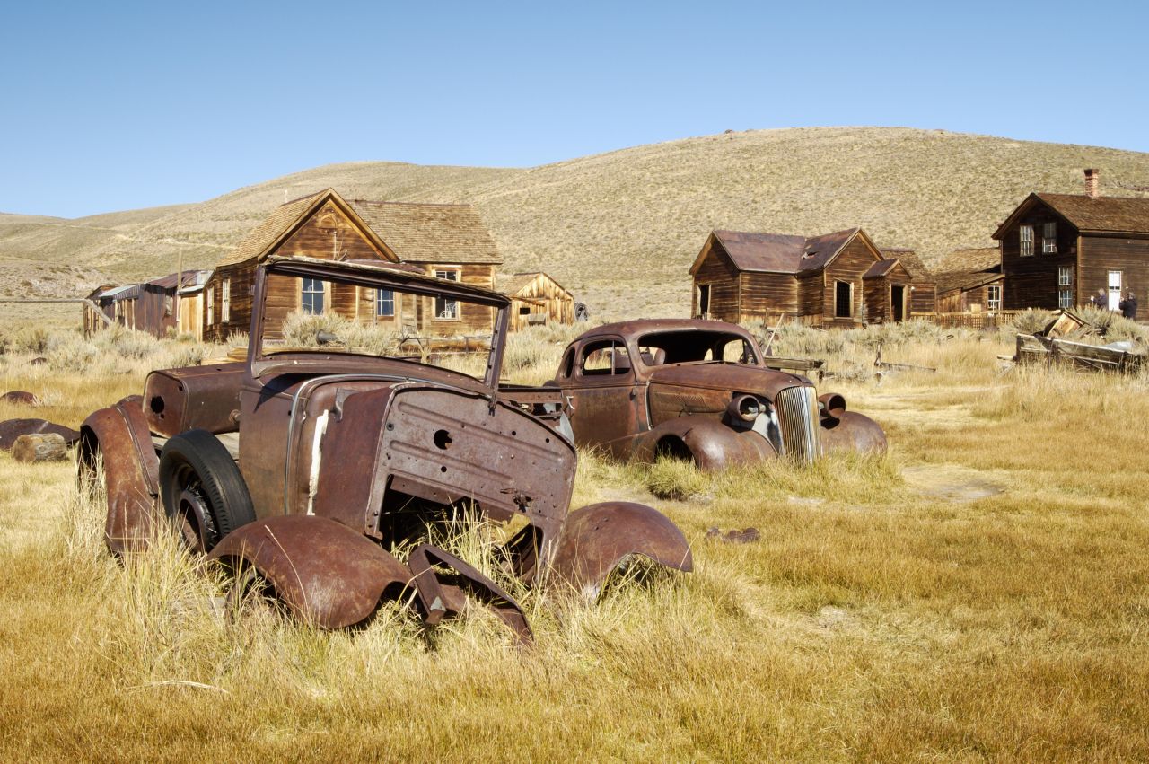 Discarded cars lie rusting in California ghost town Bodie.