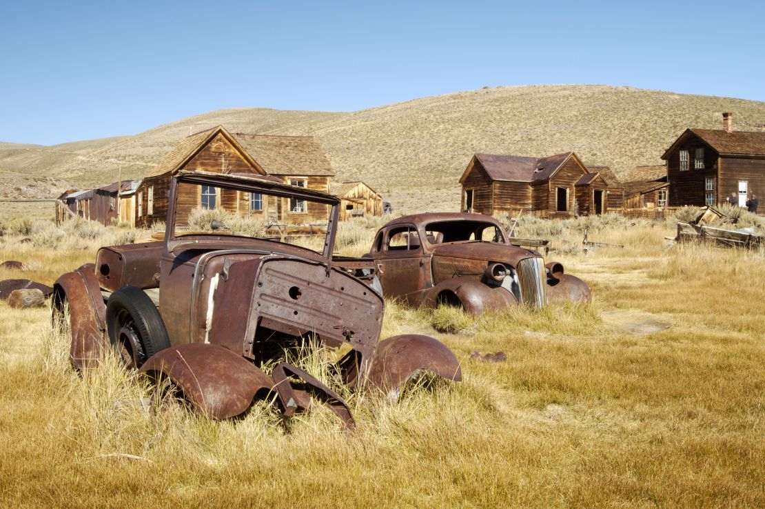 Discarded cars lie rusting in California ghost town Bodie.