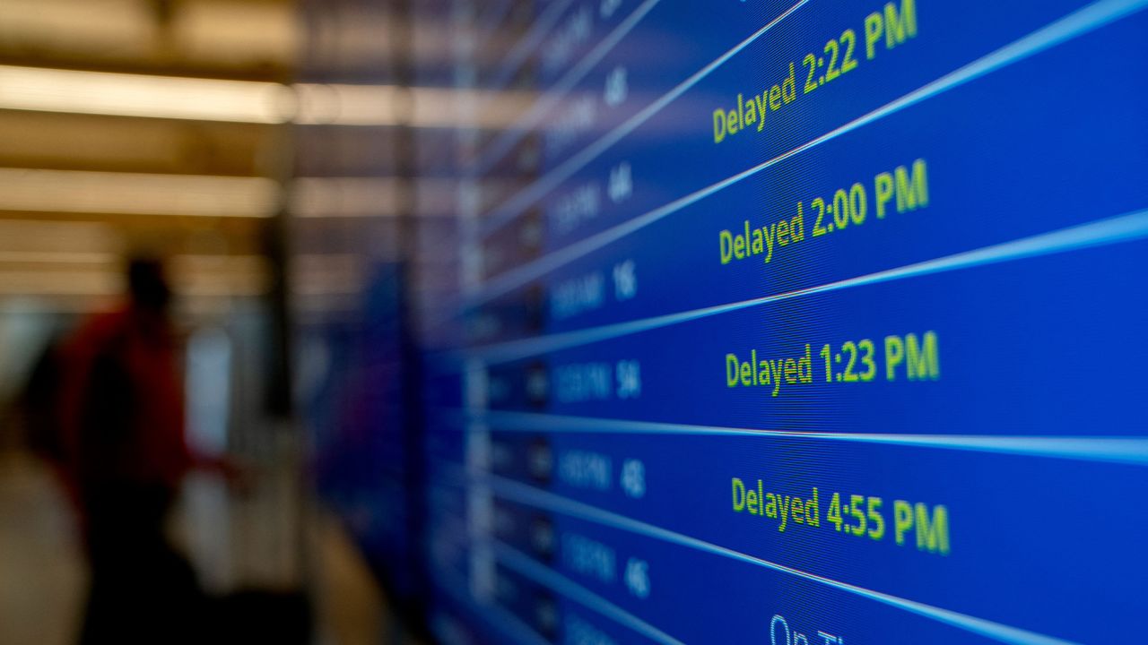 Delayed signs are displayed on the flight schedule board at Ronald Reagan Washington National Airport in Arlington, Virginia, on January 18.