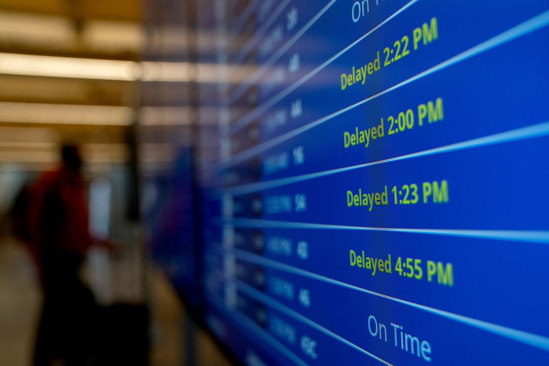 Delayed signs are displayed on the flight schedule board at Ronald Reagan Washington National Airport in Arlington, Virginia, on January 18.