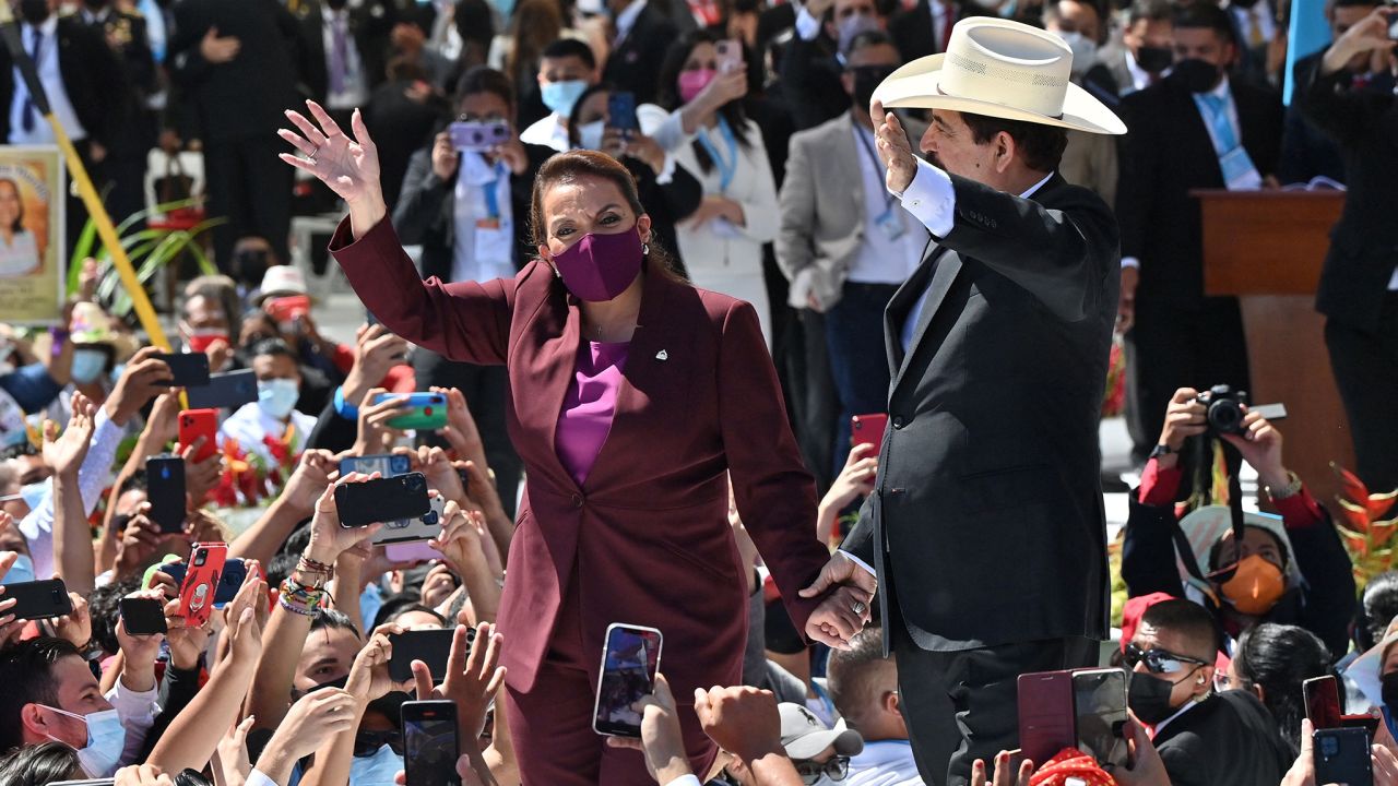Castro and her husband, former President Manuel Zelaya, greet supporters as they arrive at the National Stadium in Tegucigalpa on Thursday.